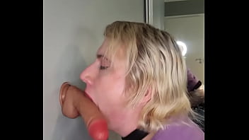 sucking on a dildo stuck to the wall