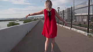 Walk along the promenade with anal plug in pussy.