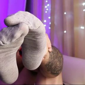 dude shows his sweaty, smelly socks from a week of use