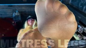 Beautiful feet of the Mistress in flesh-colored tights tease you on the table close-up (MP4 4K)