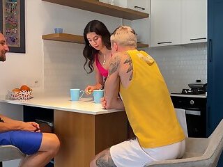 While the wife is cleaning the kitchen, her husband is giving his best friend a discreetly juicy blo