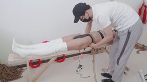 A girl in revealing clothing was tied up to a bench and subjected to sexual torment until she reached orgasm.