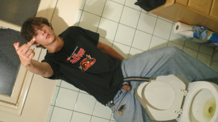 David Reed Takes A Piss While Sitting On Back of Toilet