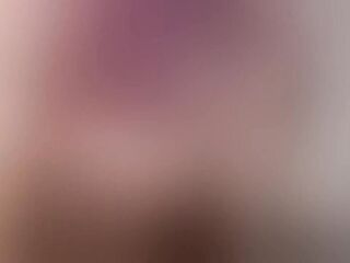 Blond floozy with nylons makes up on the sofa