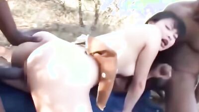 Pornstar takes on two African guys and gets double stuffed in the outdoors