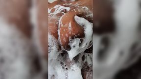 Black MILF with big boobs teases in bath