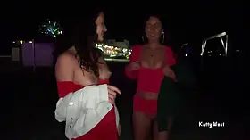 Two girls pissing on a public promenade on the beach