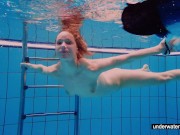 Teen girl Avenna is swimming in the pool