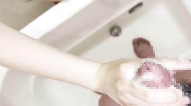 Japanese nurse soaps up huge tits while stroking cock in steaming bath