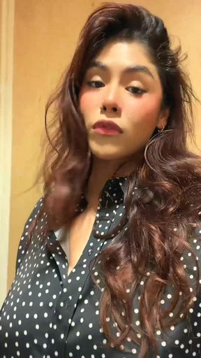 Curvy red-haired woman in polka dot shirt