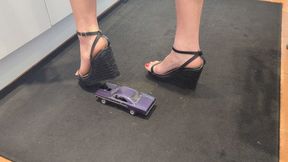 Giantess Raven Lee crushes a 1970 Plymouth GTX toy car in sexy black wedges with painted toenails high right view