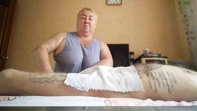 She massages my legs and jerks off my cock
