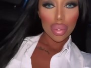 Lara Frost in a secretary costume rides in a car