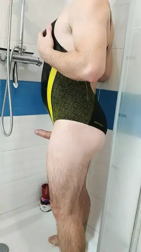 Boy in sexy Speedo one piece swimsuit get shower