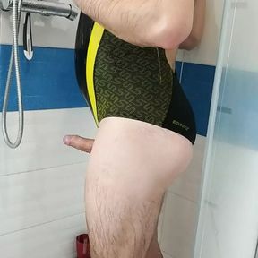 Boy in sexy Speedo one piece swimsuit get shower