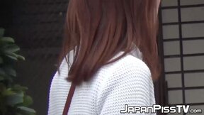 Japanese chick takes off her dress to piss outside in public