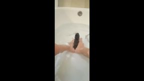 Milf plays in the tub with a big dildo