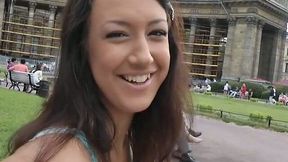 Adorable brunette girl gives a head on a red square