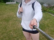 Crossdresser walks in the rain in tiny skirt