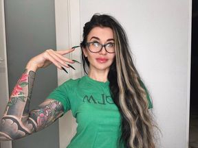 Finger snapping and sucking fingers with green long nails, long hair, glasses and face