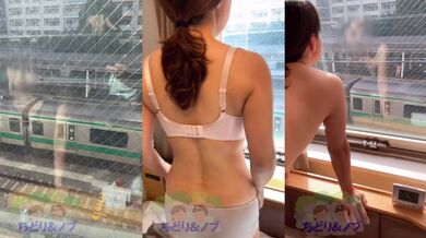 A beautiful Japanese woman getting naked from the hotel window towards the train platform.