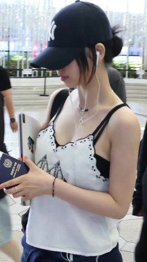 Asian woman in white tank top and baseball cap