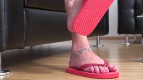 Dangling red flip flops in red bikini