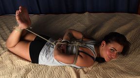Alicia: barefoot girl in grey tank top and black shorts, hogtied with hemp rope, wiggles on the bed (HD WMV)