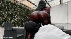 Evilwoman is pegging her slave in shiny tight leggings outdoor