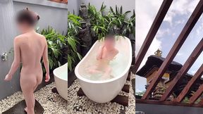 bathing in an outdoor bath in a foreign country with old men and chickens nearby