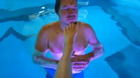 Guy sucks on two ladies' feet in a pool