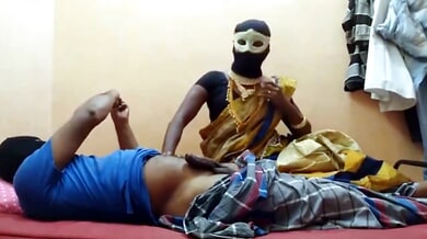 Masked ebony Indian woman teases a sensual ride on her webcam from a red bed