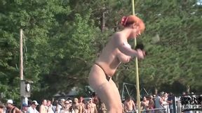 Naked ladies are posing and teasing on the stage, in front of many excited people