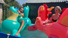 Nastya and Chloe are having fun with inflatable dragons in the pool