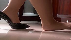 Sexy Woman With Slender Legs And Black High Heels Makes Beautiful Music On The Piano