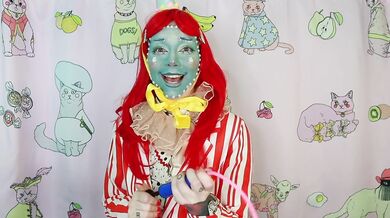 Begging for a facial while wearing a big red clown nose
