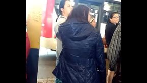 woman in nylon jacket at the bus stop