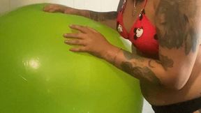 girl in swimsuit poping balloons in shower