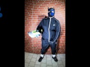 Scally Pup in shiny tracksuit pawing off and sniffing