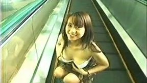 Shameless Japanese nympho gets on escalator and strips naked