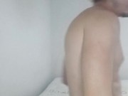 Handsome guy folding laundry naked