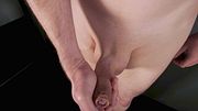 Close up erection wanking playing with foreskin of uncut shaved erect penis working his throbbing dick