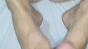 naughty girl playing with her feet on the dick