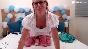 A playful solo scene with a woman in a dirndl using sex toys for pleasure.