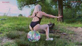 Alla is jumping happily on a small beach ball and it suddenly bursts