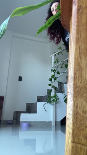 Peeking from behind staircase