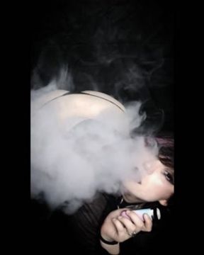 Curvy goth vaping in sheer outfit