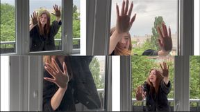 Lisa knocks with her palms on the closed glass door (custom video)