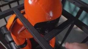 Latex prisoner in an iron cage