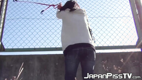Charming Japanese  tied to fence pees herself so much